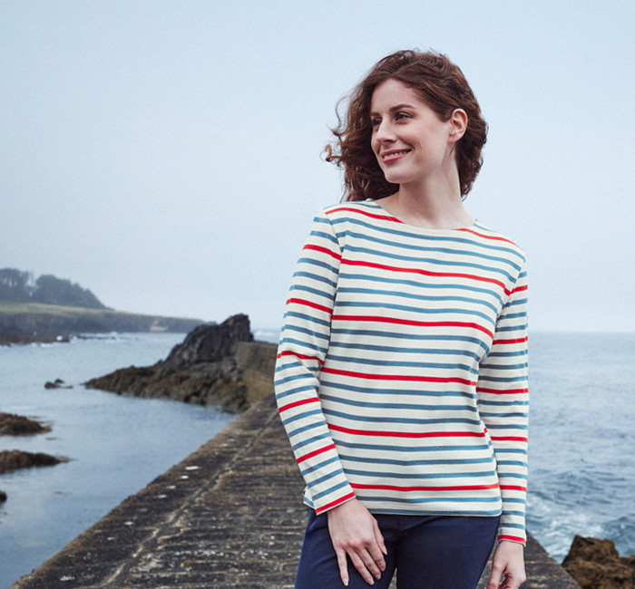 woman wearing a multicolored long sleeved breton stripe t-shirt