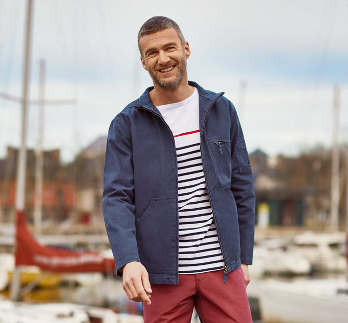 Man wearing a navy blue breton stripe t-shirt and a cotton canvas jacket from Mousqueton