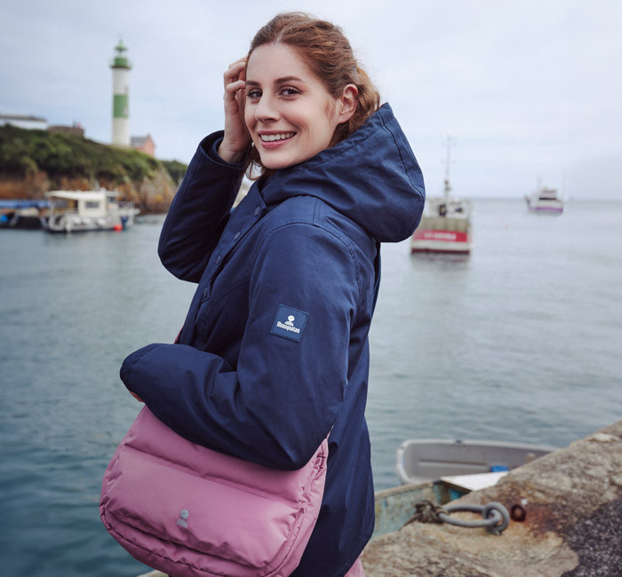 Woman wearing a navy blue waterproof jacket from Mousqueton