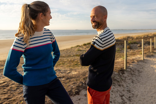 Un homme et une femme en pulls marins Mousqueton au bord de plage