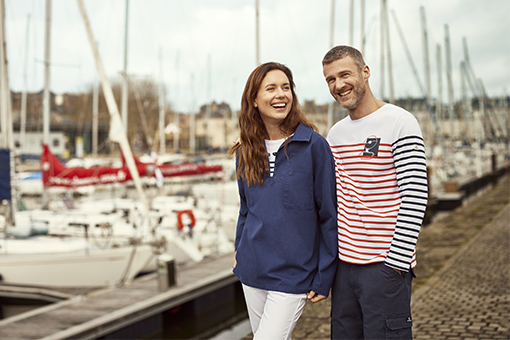 a women wearing the anniversary pea jacket and a men wearing the anniversary breton shirt with a contrasted sleeve